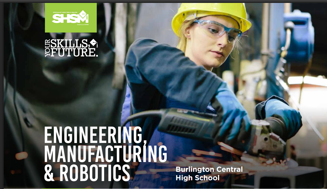 a girl working in a workshop wearing protective gear.