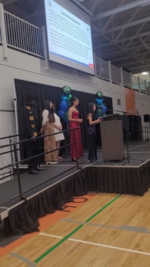 2025-26 Graduating students speaking at the podium
