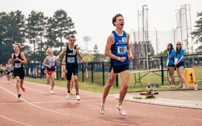 a teenage boy running outside. 