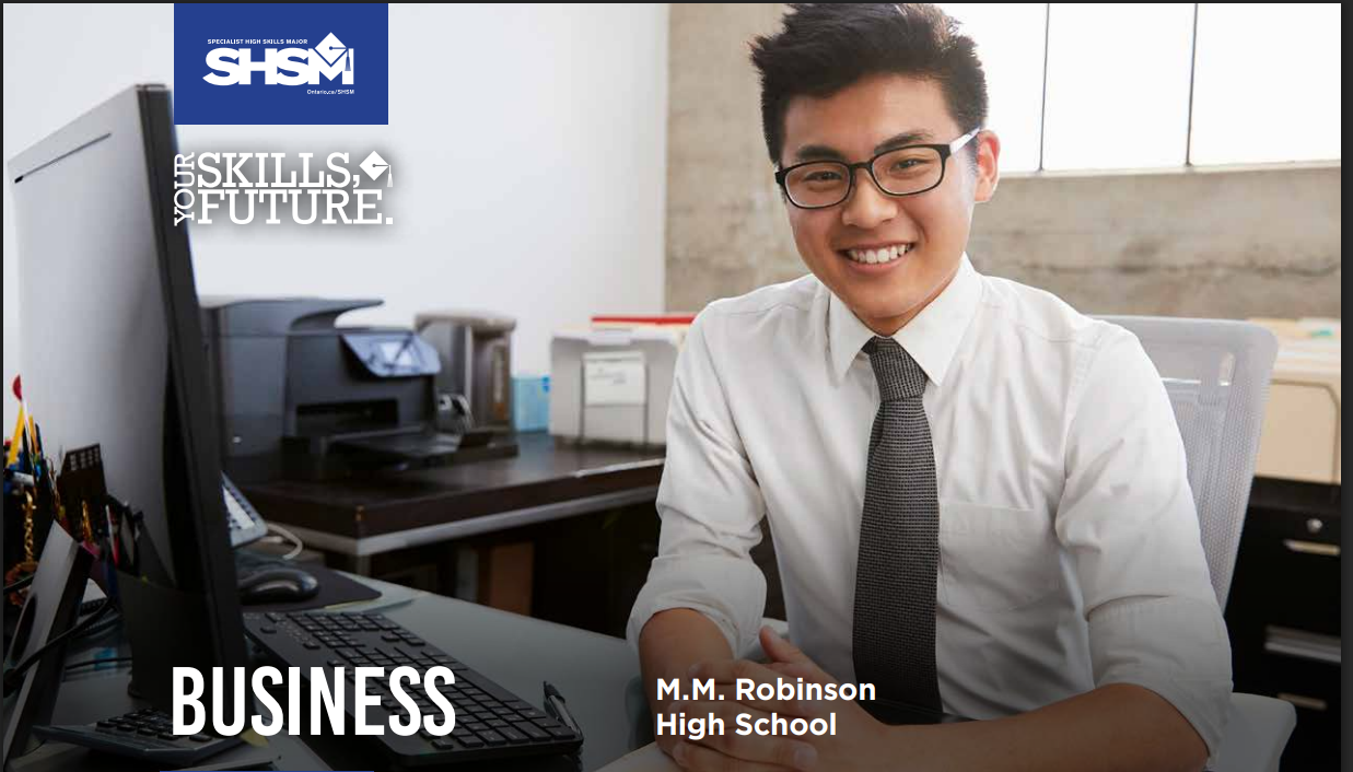 a man in a suit sitting at a desk.